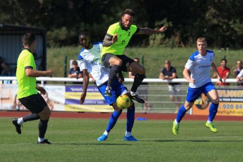 Potters Bars Chris Doyle (yellow, R) challenges Muhammadu Faal