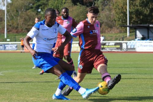 Casuals Jack Tucker (R) blocks a cross from Ken Charles