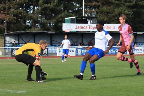 Casuals keeper Danny Bracken just beats Charles Brown to the ball