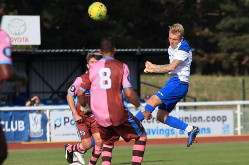Enfields Ryan Blackman heads a half-cleared ball back into the penalty area