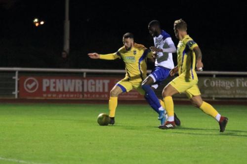 Enfields Muhammadu Faal and Stortfords Sam Robbins (L) and Ryan Henshaw