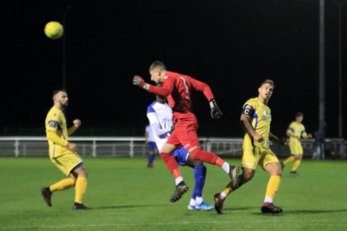 Stortford keeper Fred Burbidge heads clear