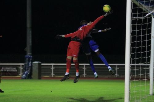 Stortford keeper Fred Burbidge palms the ball away from Muhammadu Faal