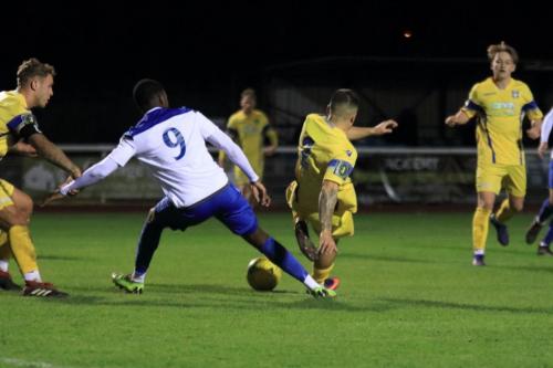 Stortfords Ben Sampayo (yellow) tackles Ken charles but the ball runs to Ryan Blackman who scores to make it 1-1