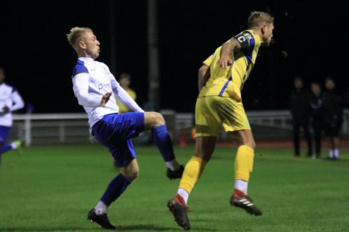 Stortfords Ryan Henshaw (R) heads clear from Ryan Blackman