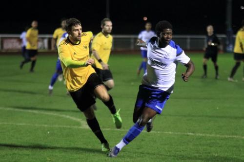 Broadfields Sam Horan (L) clears from Charles Brown
