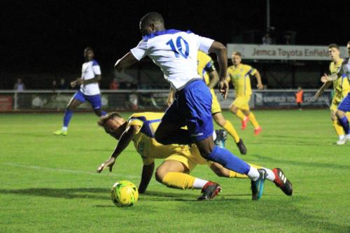 Enfields Ken Charles (10) beats Ryan Henshaw in the box