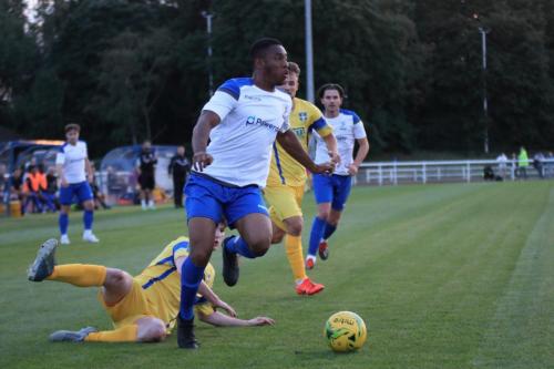 Jon Muleba (Enfield) beats the challenge of Jack Thomas (yellow, L)
