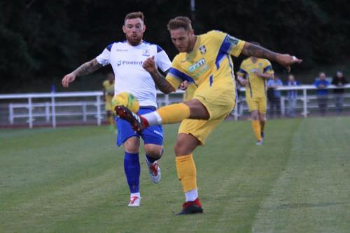 Stortfords Ryan Henshaw clears from Billy Bricknell