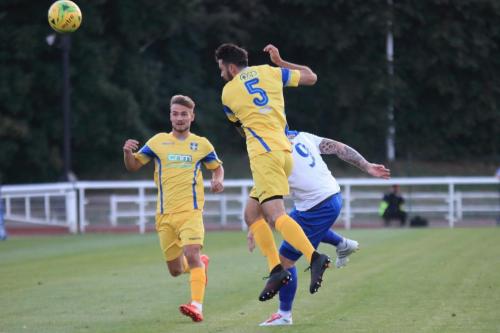 Stortfords Sam Robbins (5) heads clear from Billy Bricknell