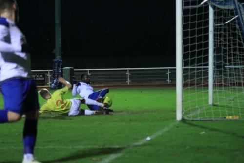 Staines Dennis Gorman stops Billy Bricknells (L) shot form crossing the line but his clearance hits Bobson Bawling for the fourth goal