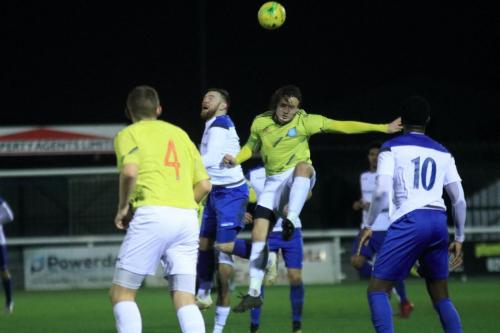 Staines Joe McEvoy (yellow) challenges Enfields Billy Bricknell