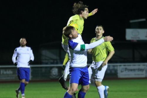 Staines Joe McEvoy (yellow) challenges Enfields Marc Weatherstone