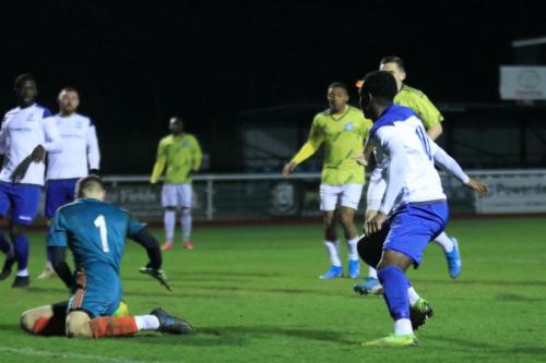 Staines keeper Jacob Adams saves from Ken Charles (R)