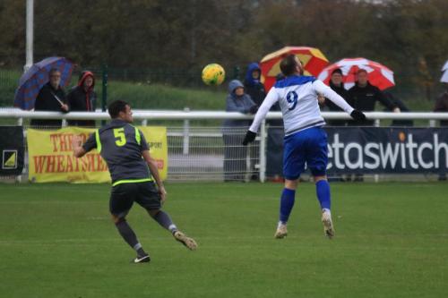 Enfields Billy Bricknell (R) flicks the ball past Zack Westlake