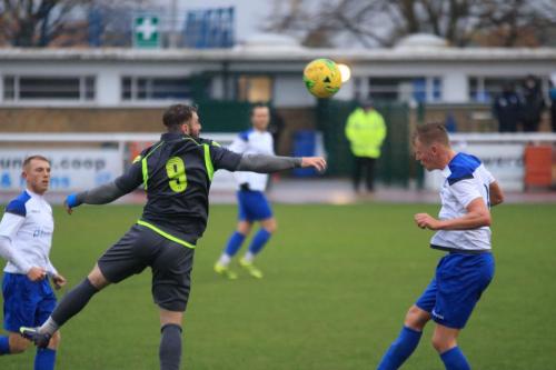 Enfields Joe Payne (R) heads clear from Kyle Tooze