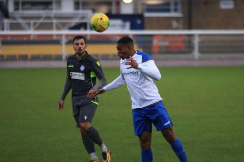 Enfields Jon Muleba (R) heads clear from Felipe Barcelos