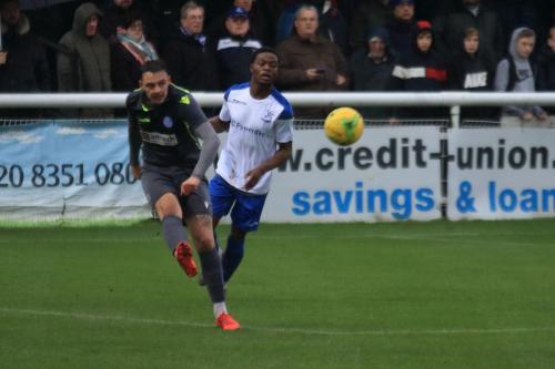 Thatchams George Jeacock (L) clears from Samson Esan