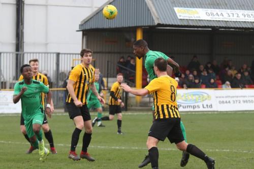 Enfield's Shaun Okojie heads over the bar
