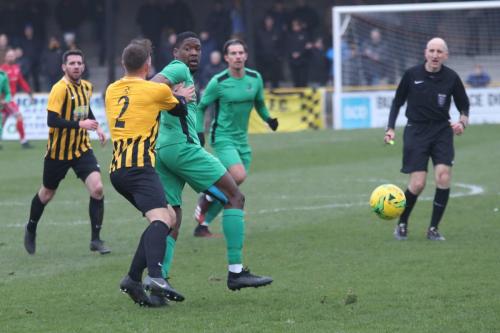 Folkestone's Josh Vincent (2) and Enfield' Shaun Okojie