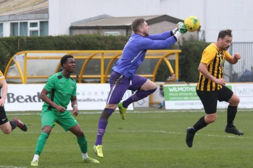 Folkestone keeper Tim Roberts punches clear