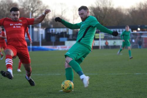 Enfields Billy Bricknell shoots under the challenge of Nathan Cooper