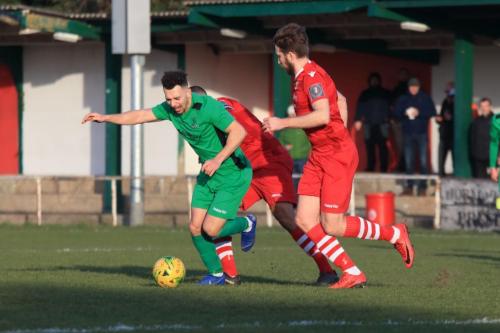 Enfields Lyle Della-Verde (L) is challenged by Lewwis Spence as Remi Sutton covers