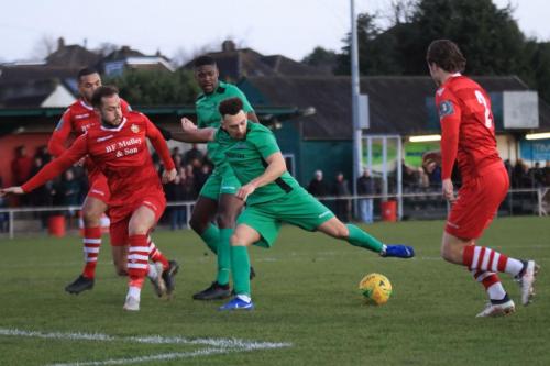 Enfields Lyle Della-Verde stretches for the ball