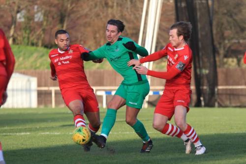Enfields Sam Youngs challenged by Lewwis Spence (L) and Mickey Parcell