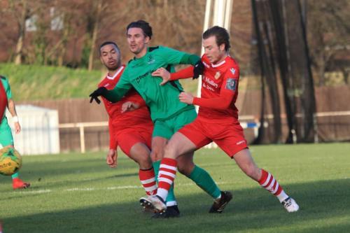 Enfields Sam Youngs challenged by Lewwis Spence (L) and Mickey Parcellx