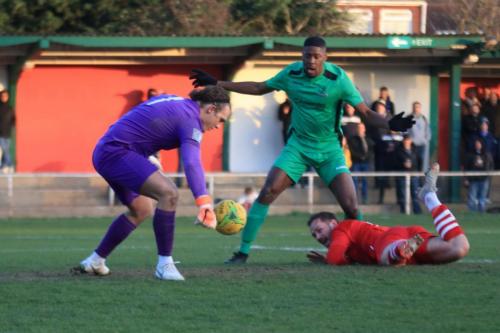 Hornchurchs Arthur Lee (R) ushers the ball back to Joe Wright as Shaun Okojie looks on