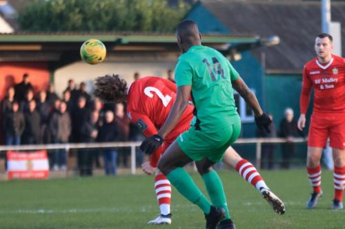 Hornchurchs Mickey Parcell (2) heads clear from Shaun Okojie