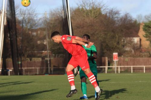 Hornchurchs Nathan Cooper heads clear from Junior Mubiayi