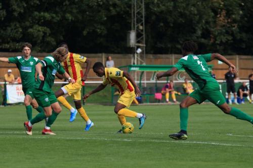Enfields Ken Charles tries to make room for a shot, challenged by Izunna Ikebuasi (R) and Will Salmon
