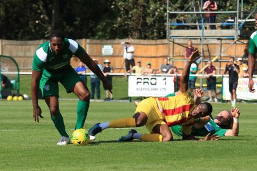 Enfields Muhammadu Faal is stopped by Jerry Nnamani (L) and Will Salmon