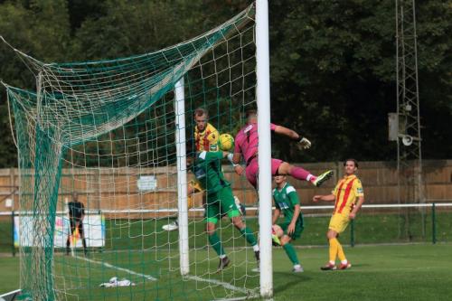 Enfields Sam Hatton challenges at the far post