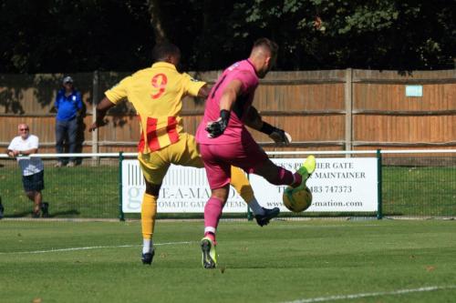 Leatherhead keeepr Zaki Oualah clears from Ken Charles after receiving a tricky backpass