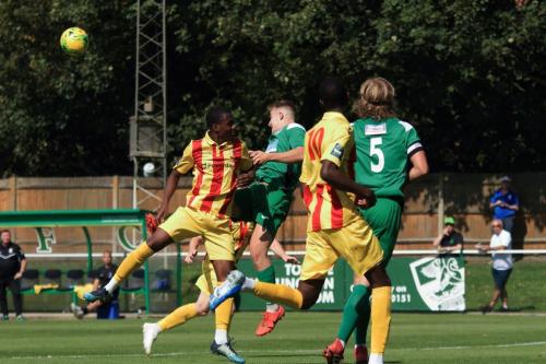 Leatherheads Charlie Hester-Cook (green, L) heads clear from Ken Charles