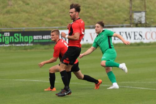 Enfields Lewis Taaffe shoots watched by Thomas Day (L) and Stacey Freeman