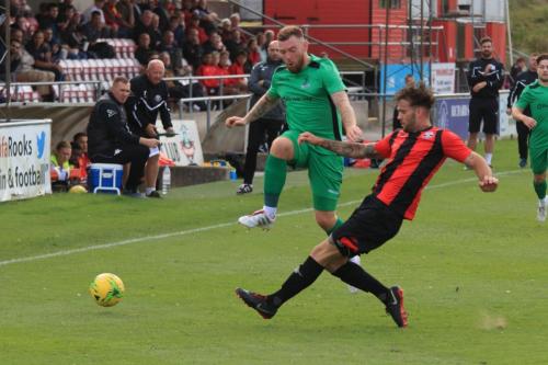 Lewes Stacey Freeman (R) clears from Billy Bricknell