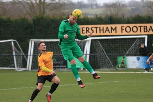 Enfields Billy Bricknell heads on goal watched by Chace Jacquart