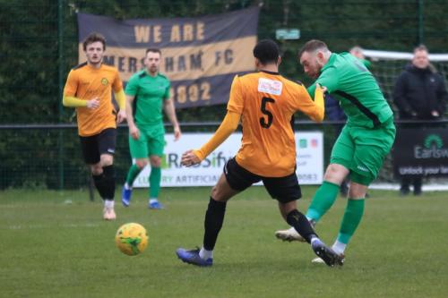 Enfields Billy Bricknell shoots past EJ Mensahs attempted block
