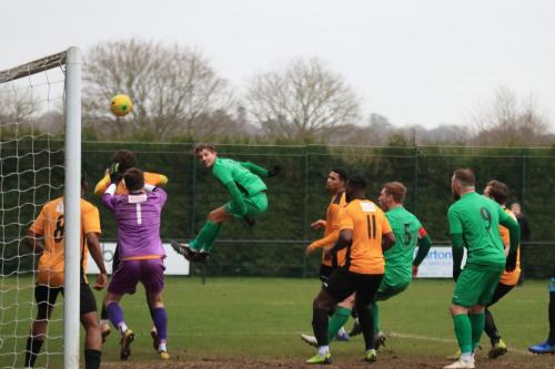 Enfields Sam Youngs (green, L) challenges at a corner  Im not sure if he actually made contact with the ball
