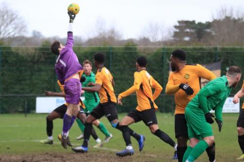 Merstham keeper Matte Pierson just gets his finger tips to a cross