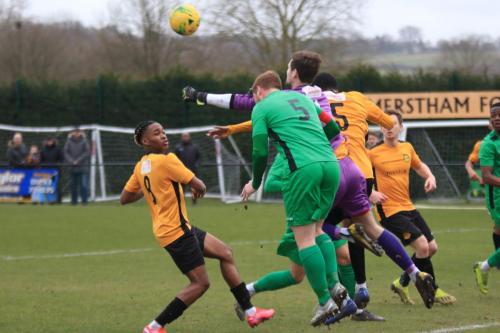 Merstham keeper Matte Pierson punches clear from  Marc Weatherstone, but the ball falls to Sam Youngs to score Enfields second
