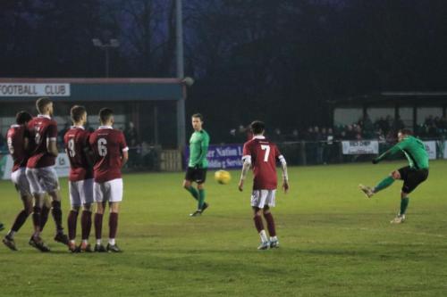 Enfields Billy Bricknell tries to curl a free kick round the wall