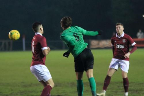 Enfields Sam Youngs (green) chests the ball across the area in the build-up to the winning goal