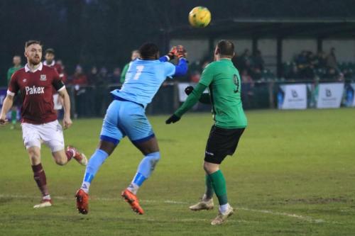 Potters Bar keeper Ravan Constable punches clear from Billy Bricknell (R)