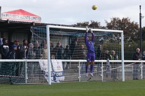 Leatherhead's Zaki Oualah has the crossbar covered as a long-range effort dips just over