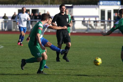 Lyle Della-Verde (partially obscured) shoots